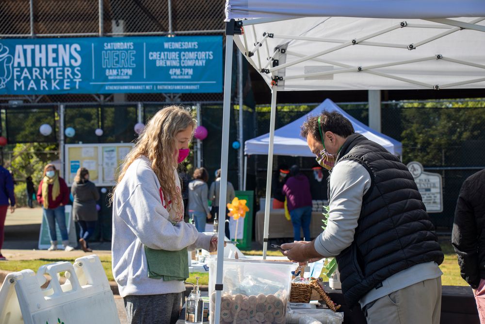 Vendor and shopper at Athens Farmers Market