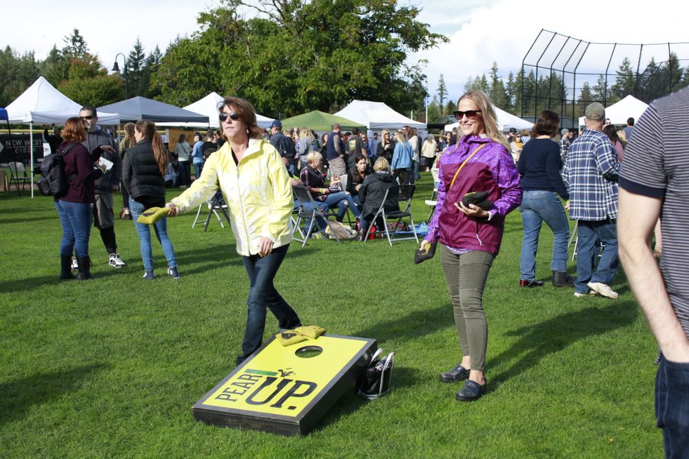 Ladies playing "pear up" during a cider festival at the park.