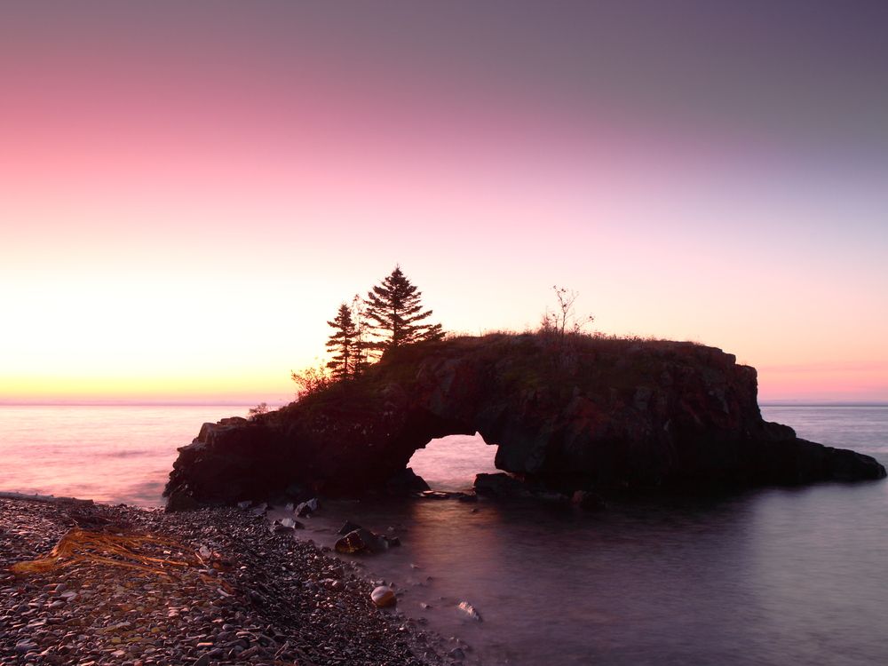 Silhouette of Hollow Rock during sunset