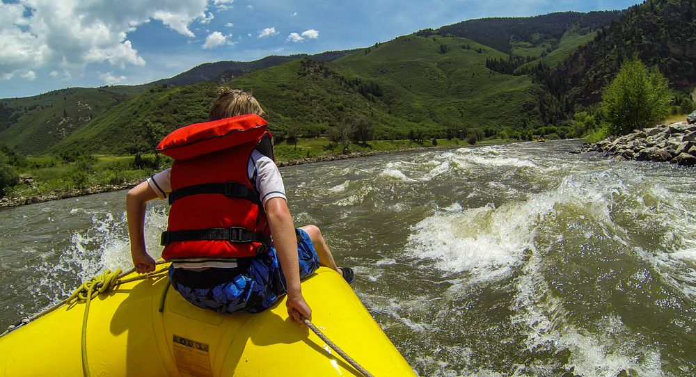 A boy on a rafting boat along Glenwood Canyon