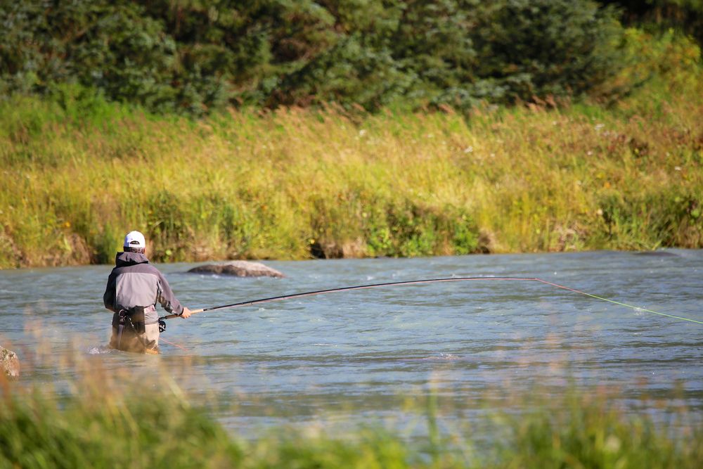 A person fishing on Chilkat River