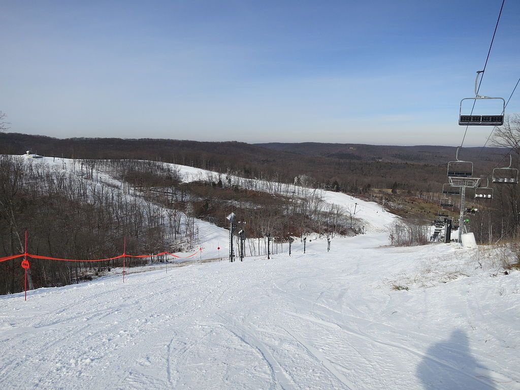Snow covered mountain view of Hidden Valley, with cable cars on top.