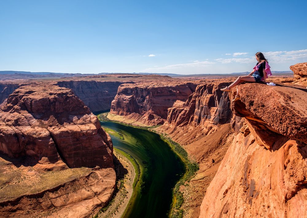 A hiker admiring Horseshoe Bend
