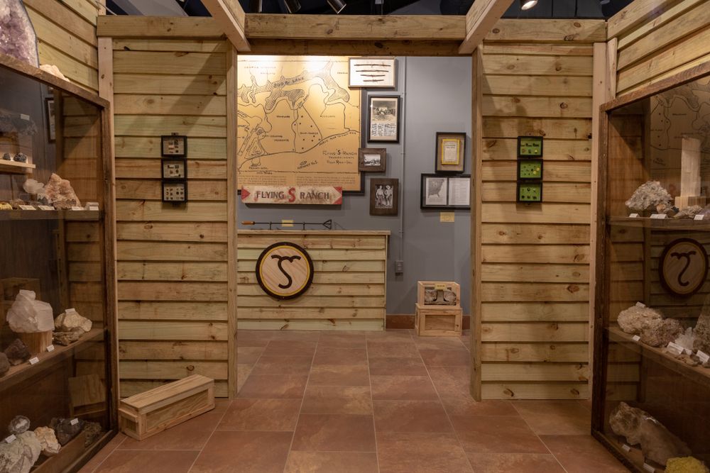 Wooden shelves, archway and a map inside the museum.