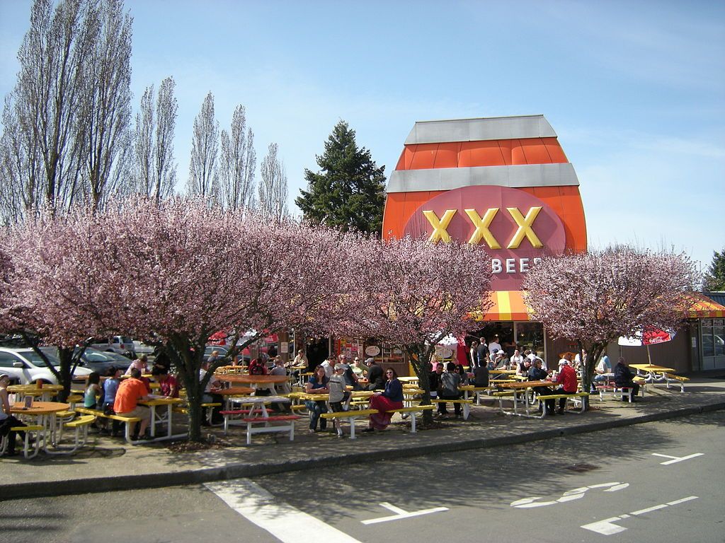 People eating outside Triple XXX Rootbeer Drive-in.