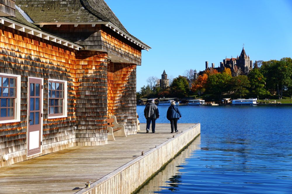 Two people walking around the Boldt Yacht House