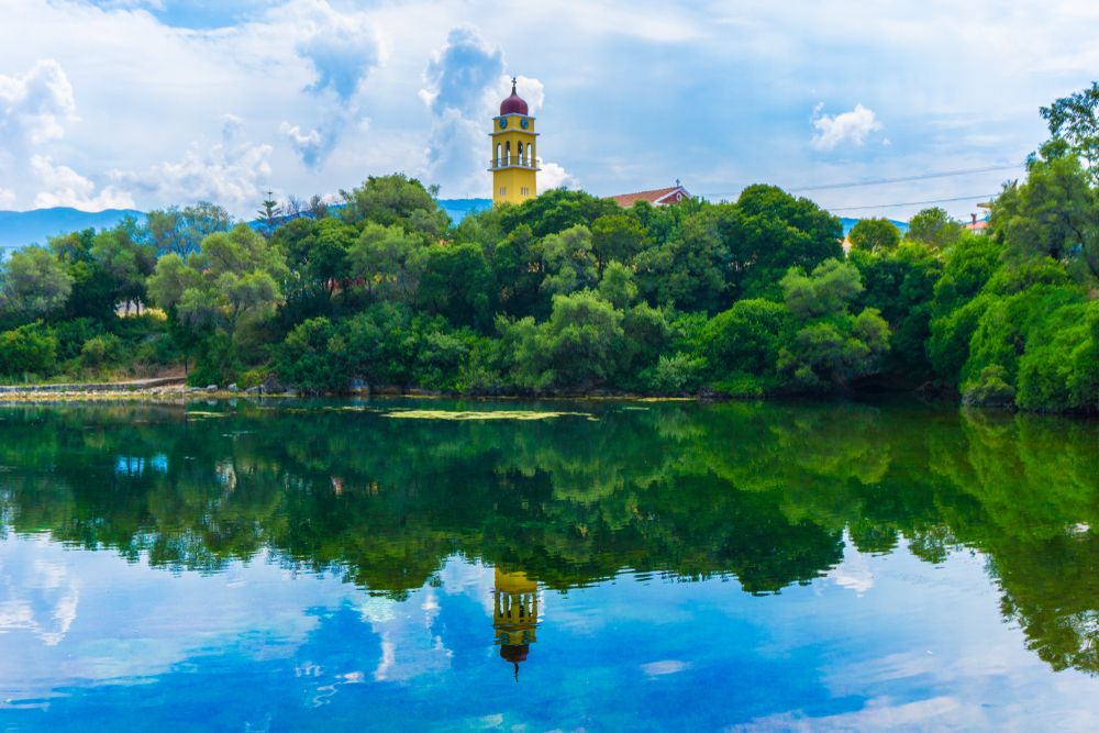 Reflective, still waters of Karavomilos Lake