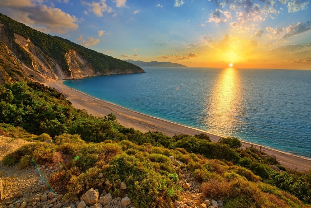 Sunset reflecting on Myrtos Beach waters