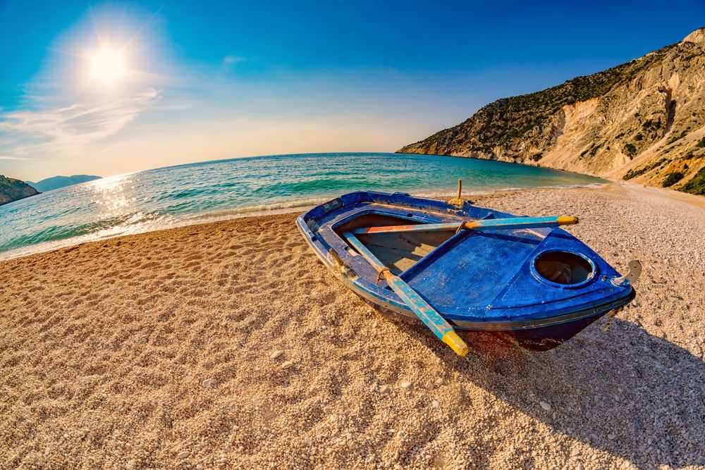 A boat on the shore of Myrtos Beach