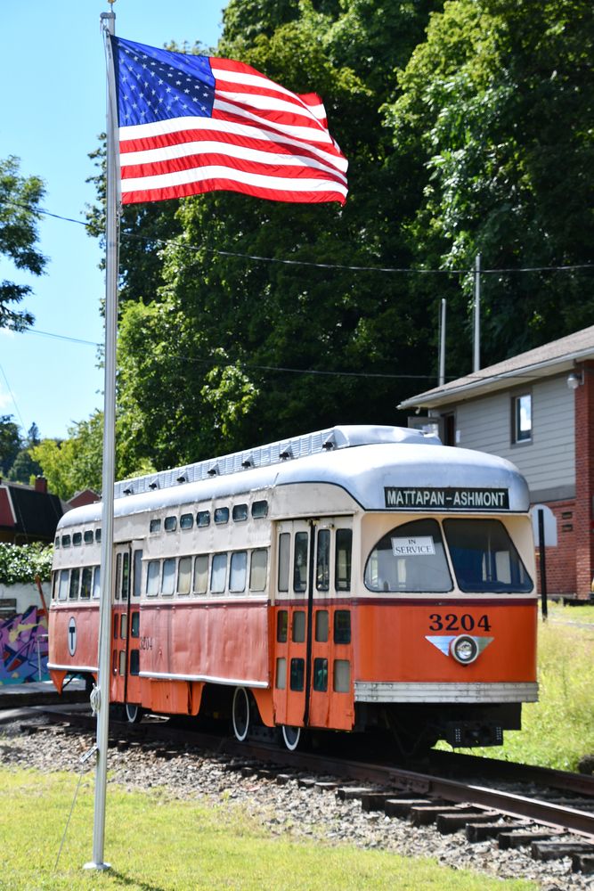 An orange trolley at the Trolley Museum of New York