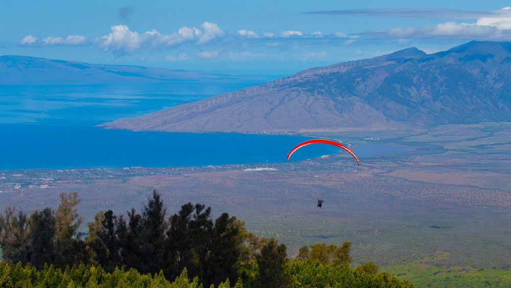 A person paragliding over Maui