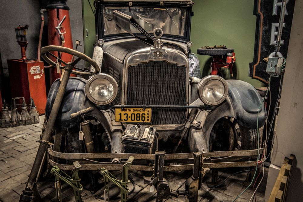 A vintage vehicle inside the R.E. Olds Transportation Museum