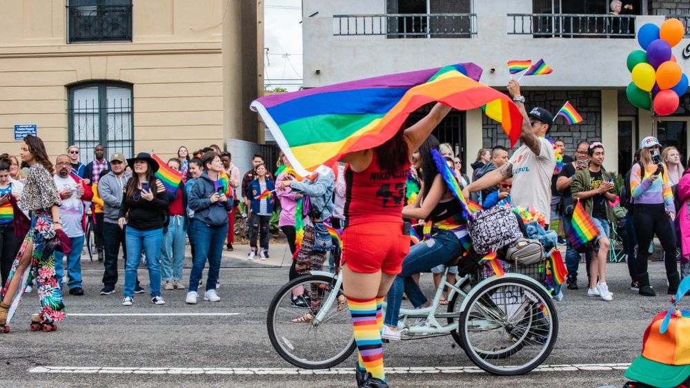 People holding a pride flags at the Long Beach Pride