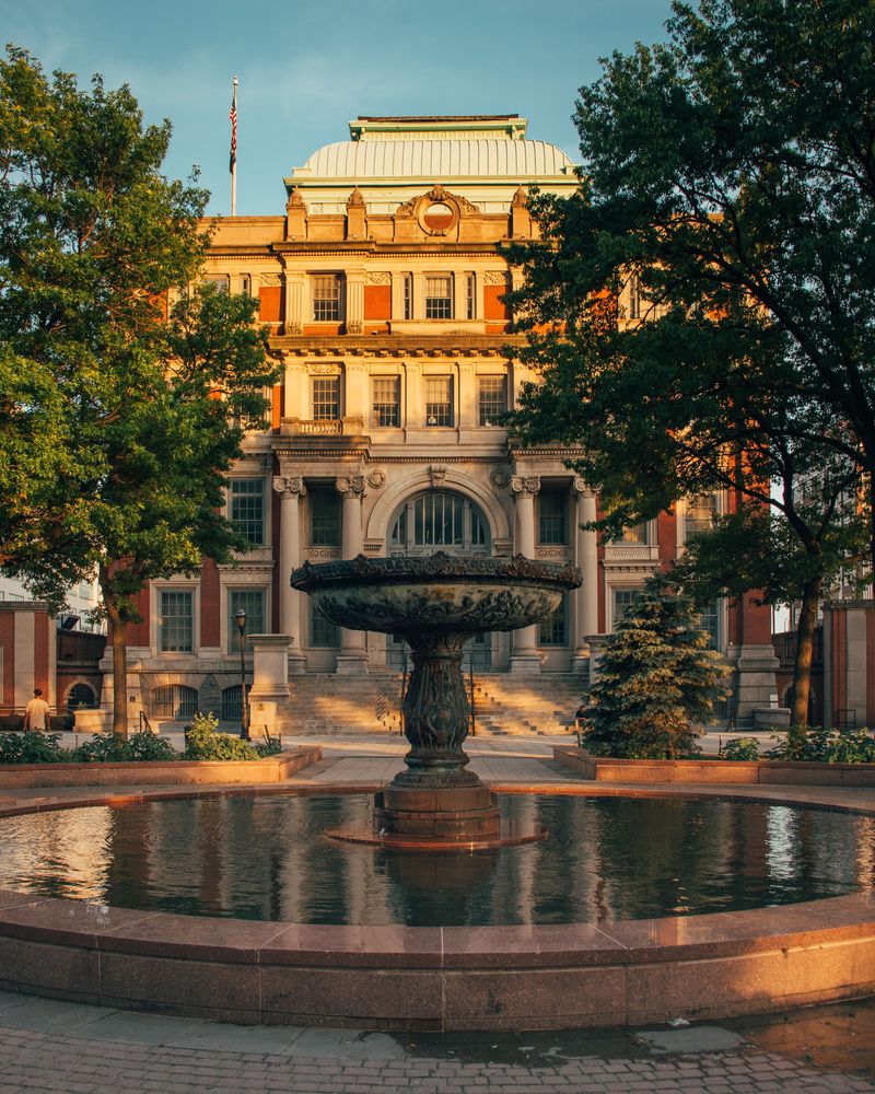 Front exterior view of the courthouse and a fountain.