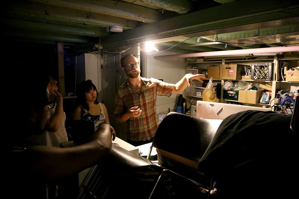 A man explaining the art of flux factory.