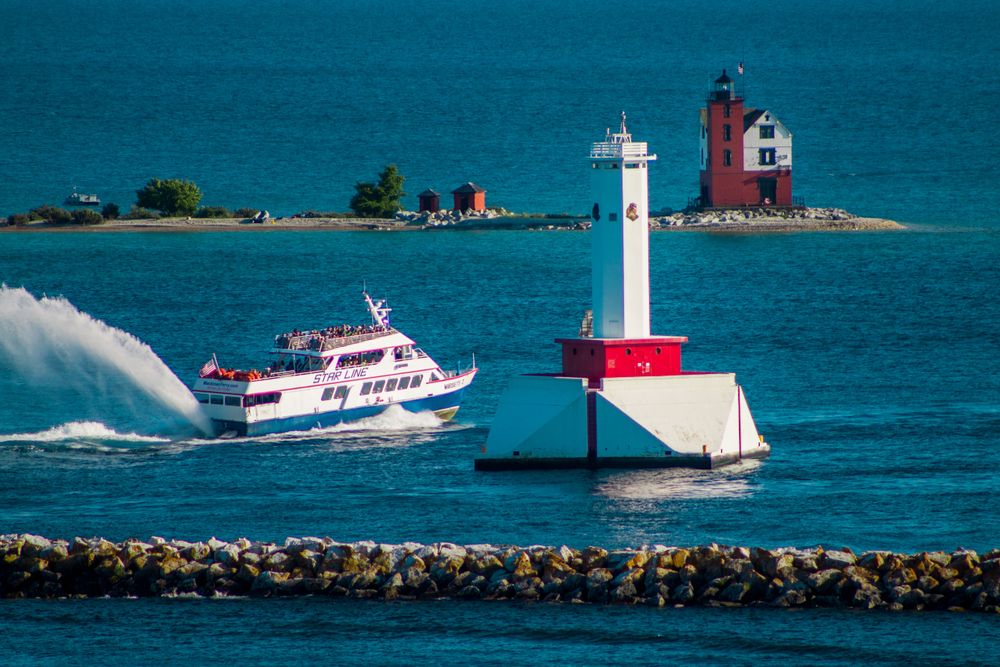 The Star Line Mackinac Island Ferry passing two lighthouses