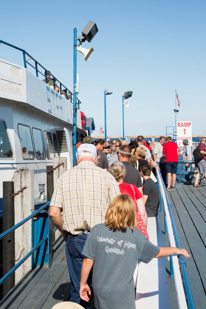 Tourists standing in line to board the Star Line Mackinac Island Ferry