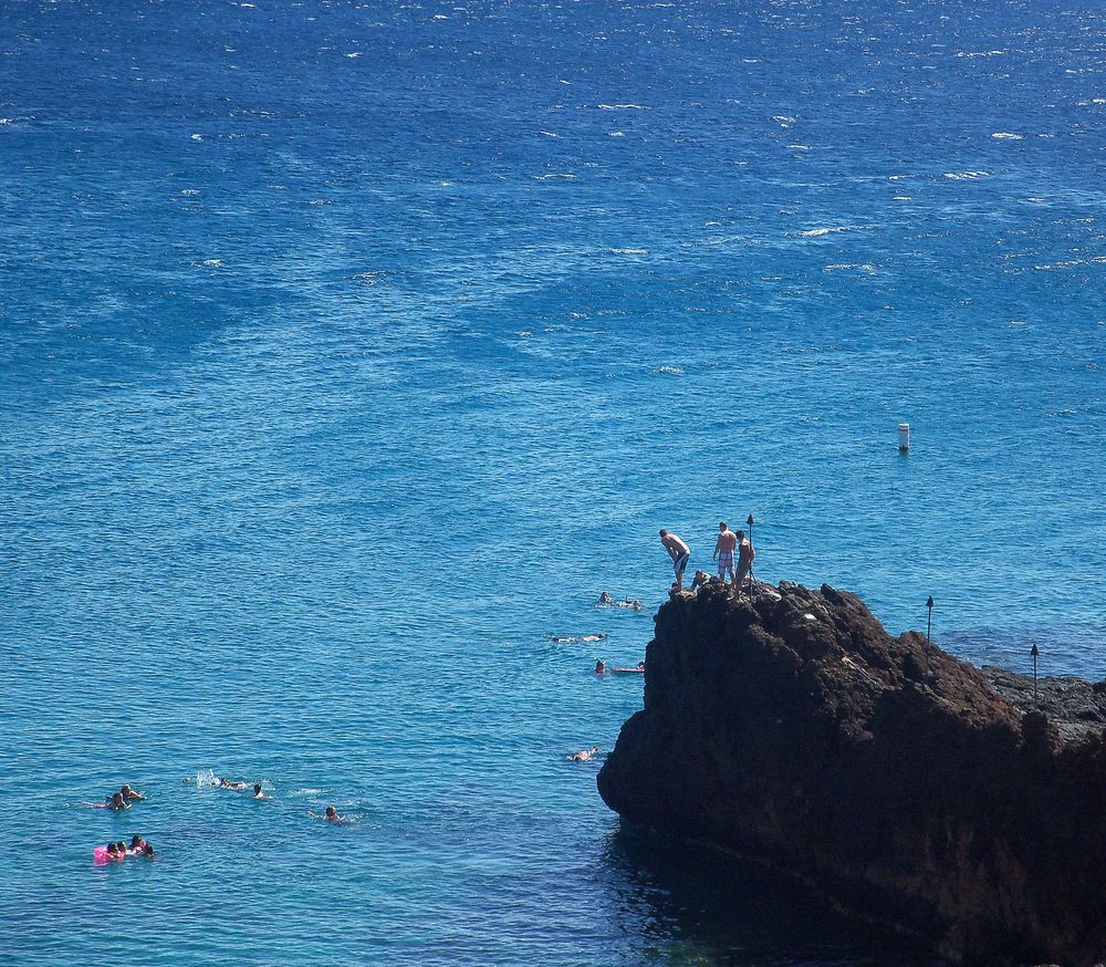 People cliff-diving at Black Rock Beach