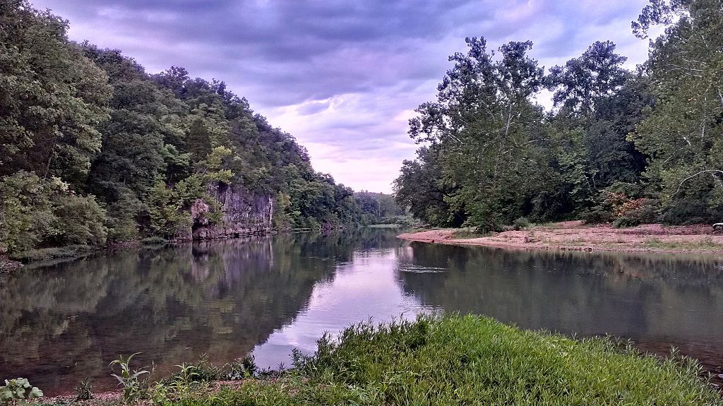 Scenic view of the still waters on Meramec River on a cloudy day.