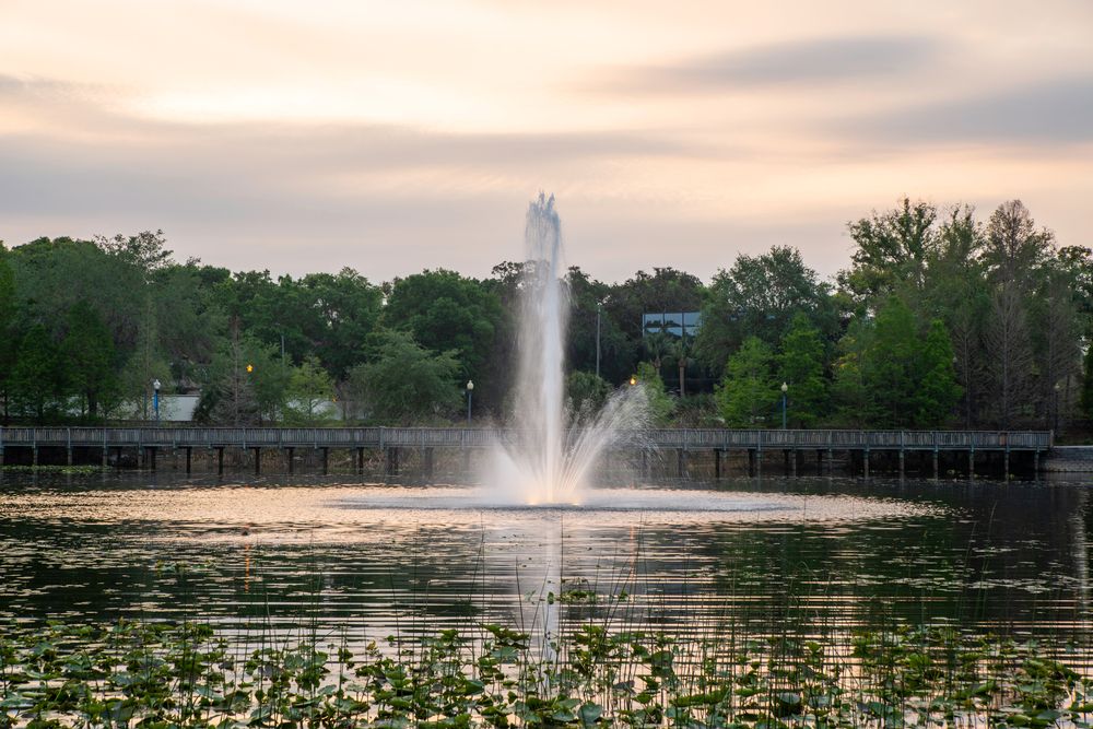 A water fountain in the middle of Lake Lily Park's waters