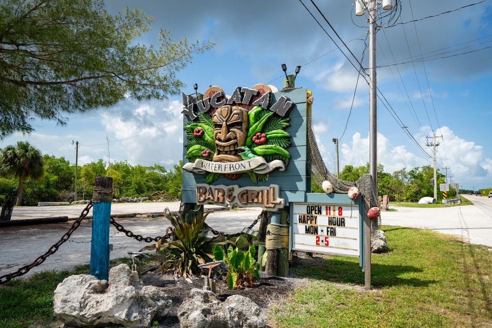 Road sign of Yucatan Waterfront Bar and Grill