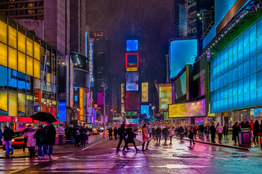 People walking around Times Square at night