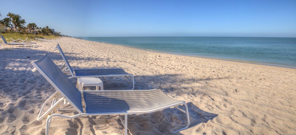 Two beach chairs on Lowdermilk Park's white sand