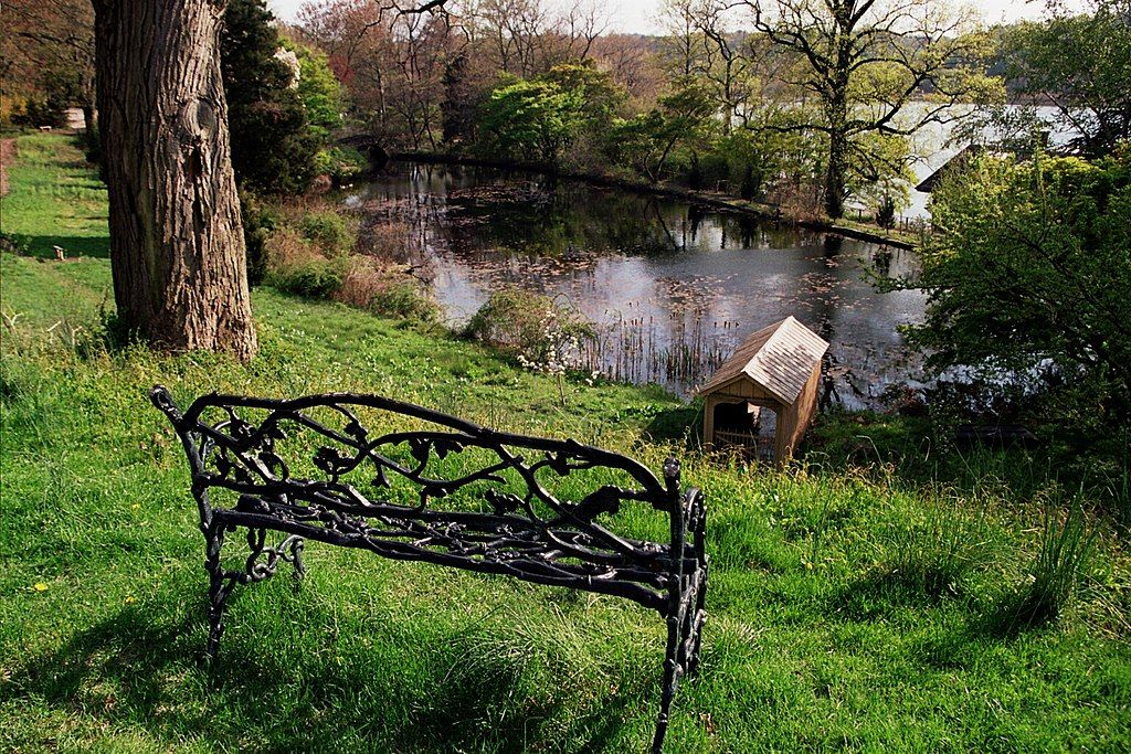 Metal bench overlooking a pond at Cedarmere