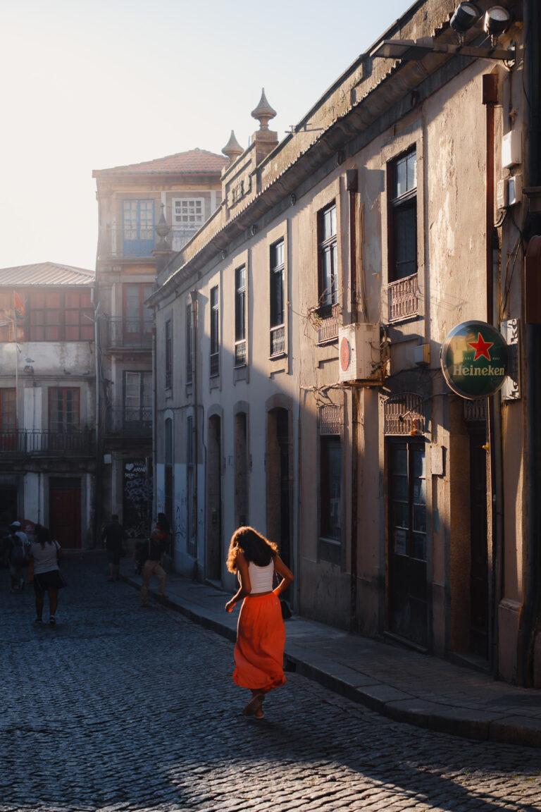 Golden sunlight bathes the charming cobblestone streets of Porto