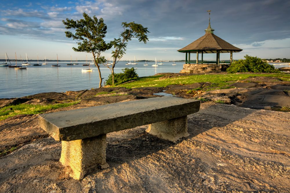 A stone bench overlooking the waters at Larchmont Manor Park