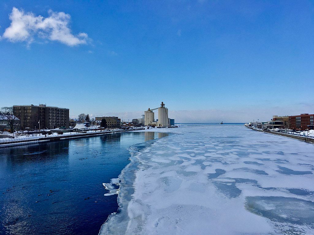 Northward face of oswego river - towards lake ontario with the top of the water frozen.