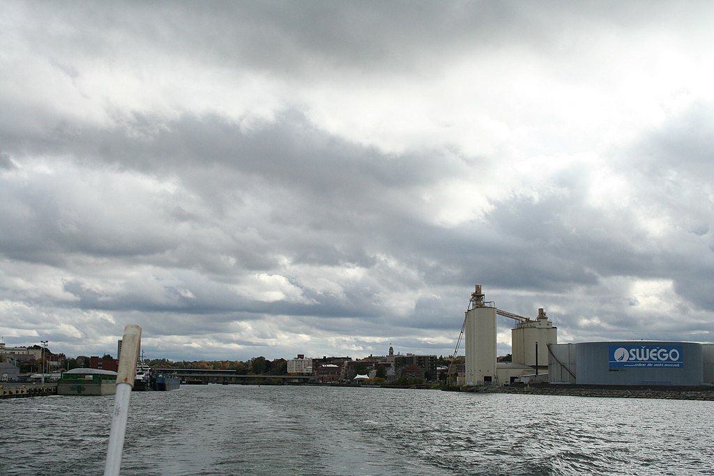 The back view of the oswego river on a cloudy day.