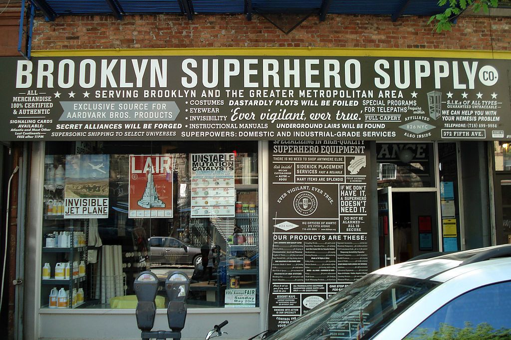 Exterior of the brooklyn superhero supply co. with a car parked in front.