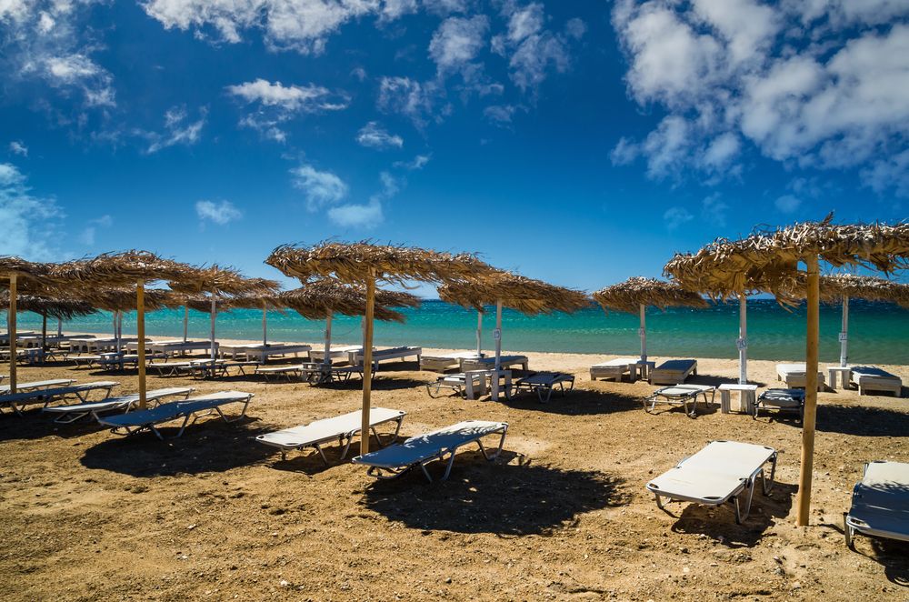 Straw umbrellas and loungers on Golden Beach's sand