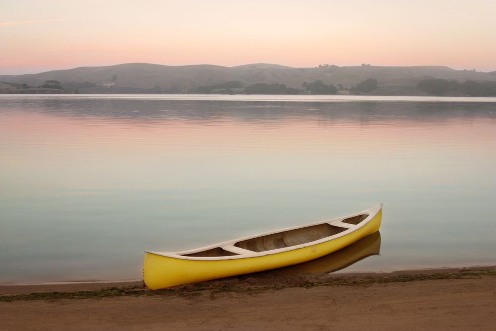 An empty yellow canoe at Tomales Bay.