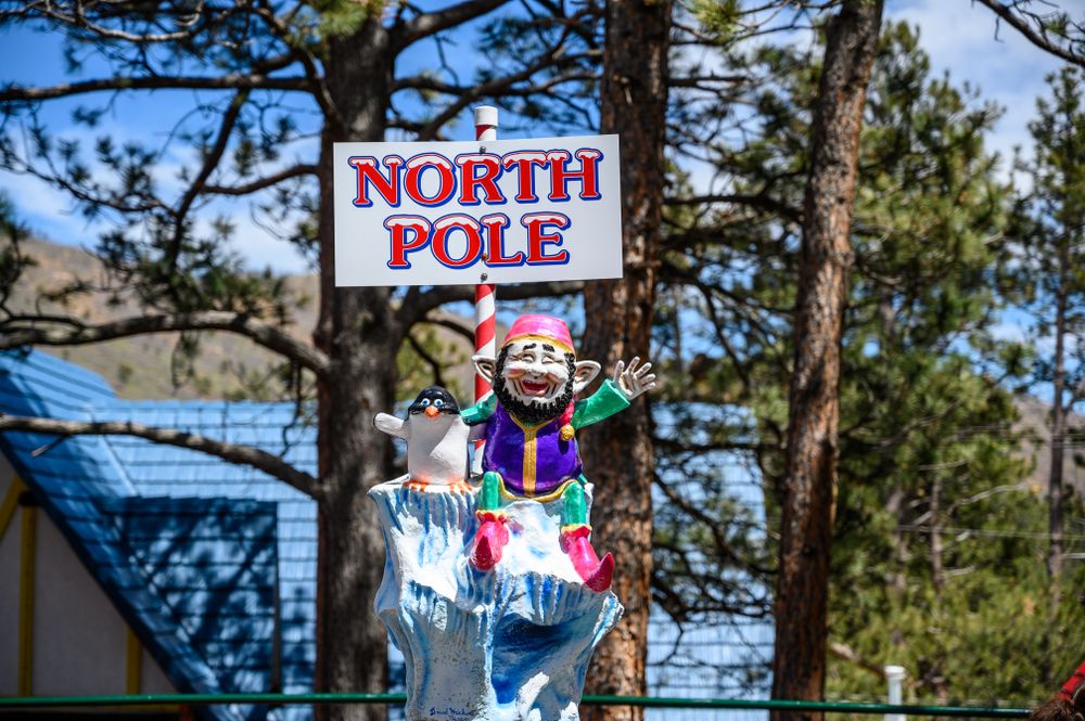 Little elf sculpture holding up a sign at North Pole Colorado Santa’s Workshop
