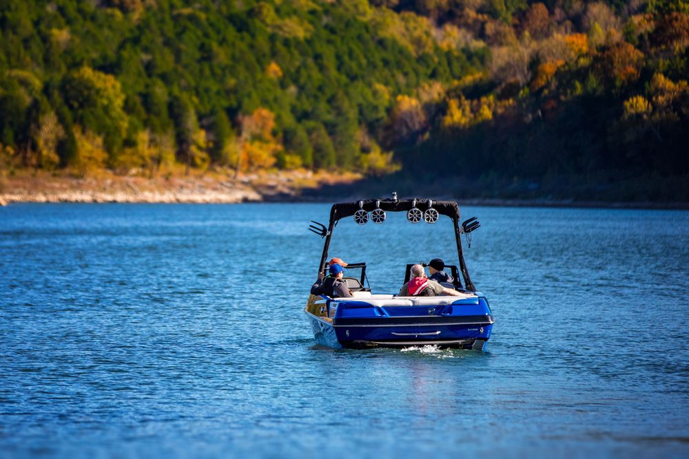 Family riding a boat on the waters of Paris Landing State Park