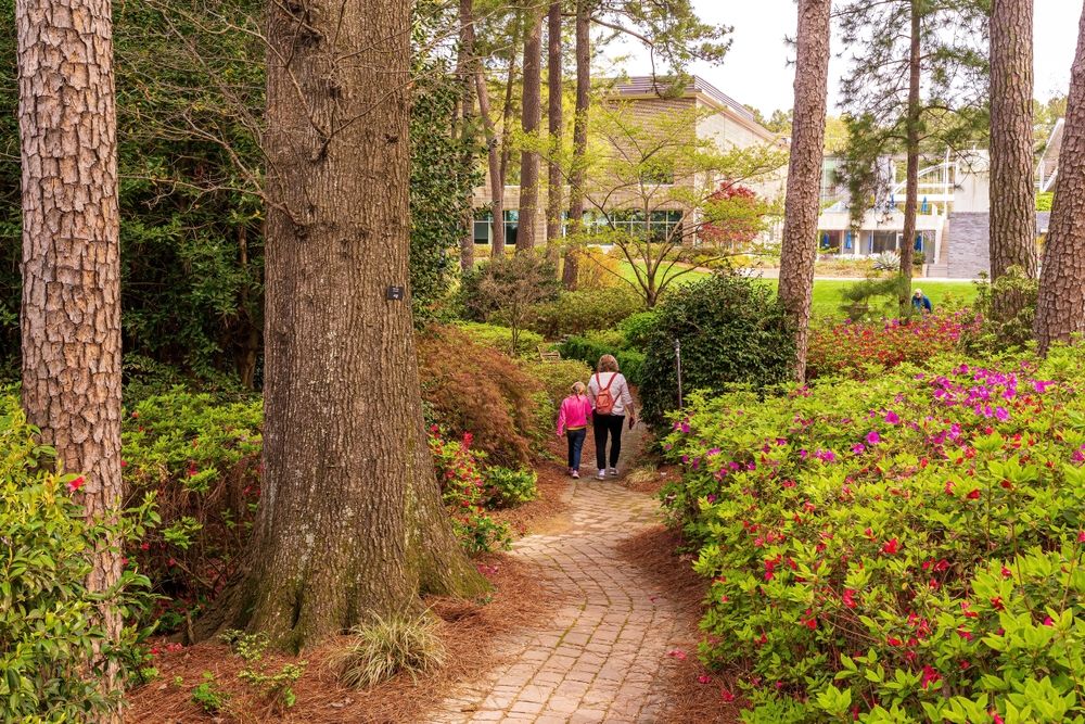 People walking along WRAL Azalea Garden
