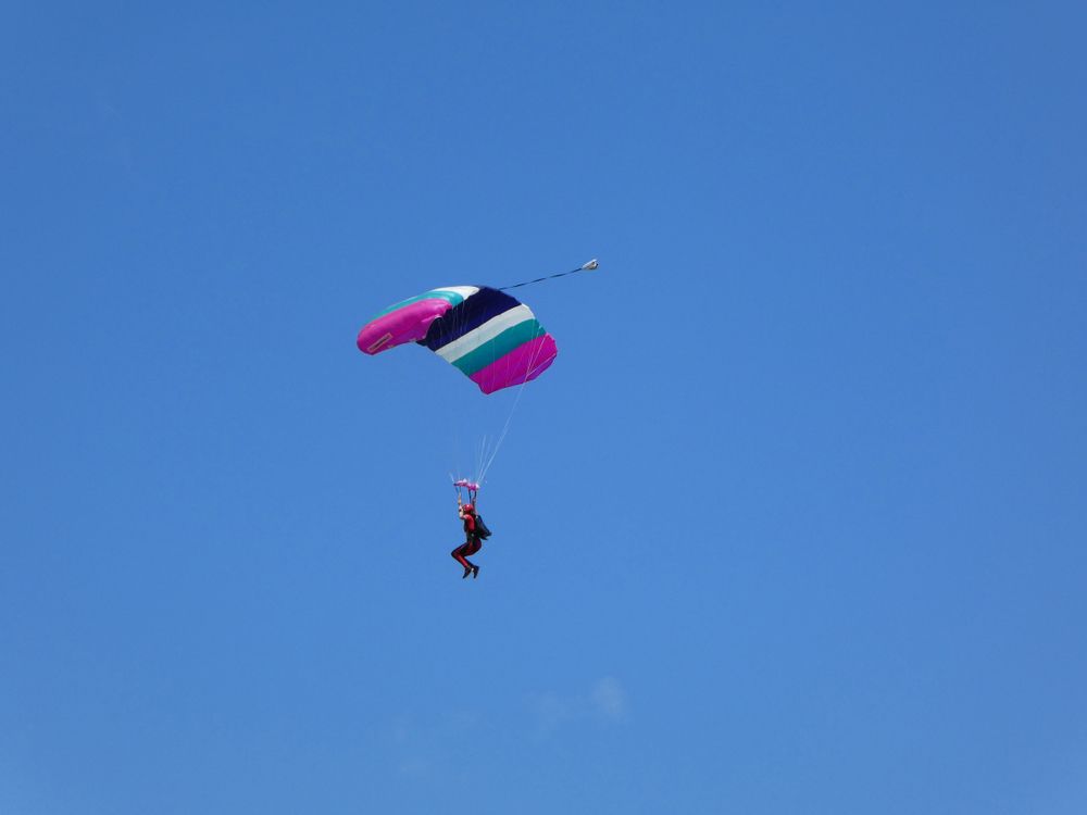 A skydiver with a colorful parachute over Chicagoland Skydiving Center