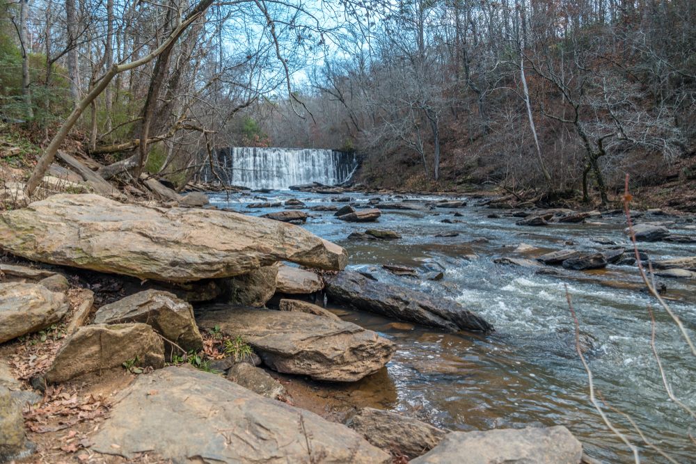 Water streaming from the roswell mill waterfall and big rocks.
