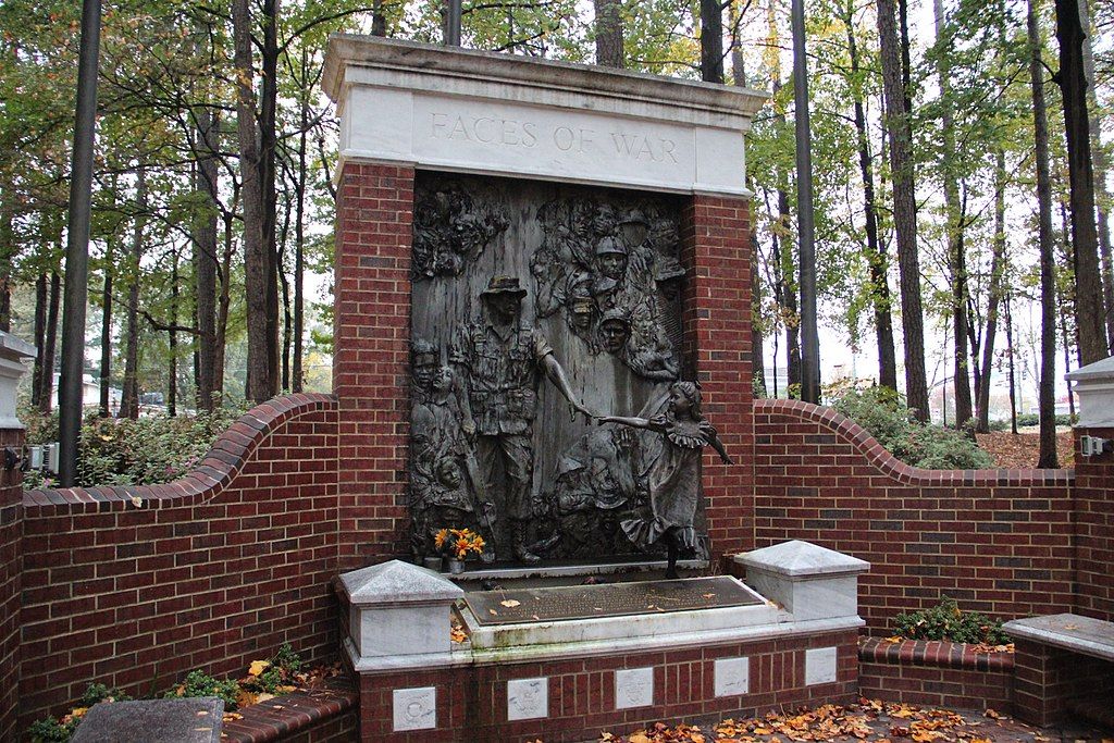 A near view of the "faces of war" memorial bronze sculpture.