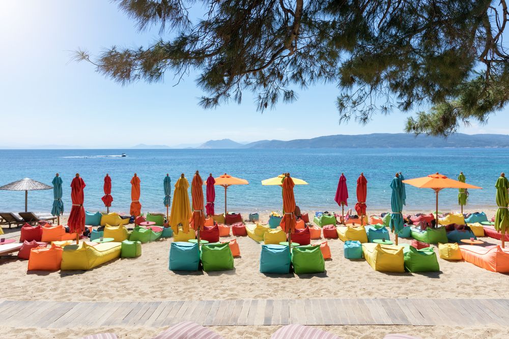 Colorful beach umbrellas and chairs at Agia Eleni Beach