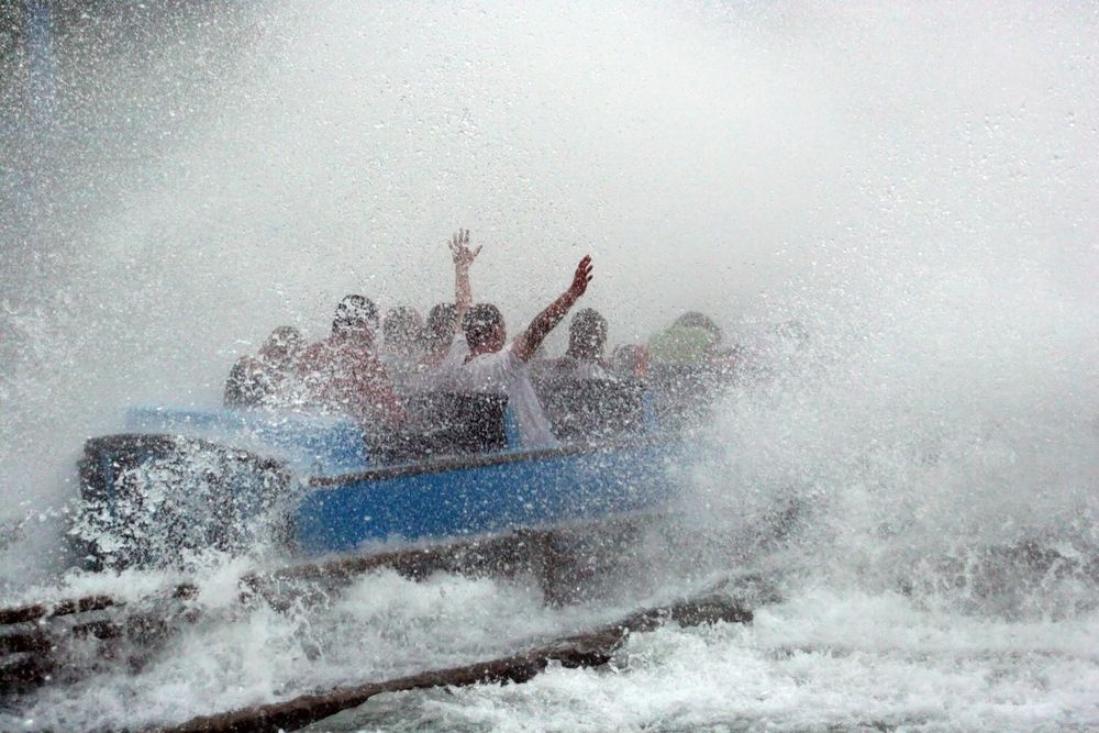 People splashed with water during a ride in Six flags.