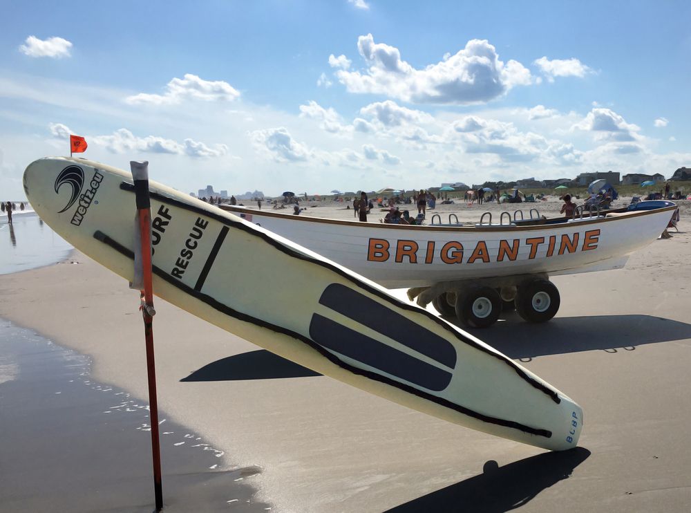 Surfboard and a boat at Brigantine Beach