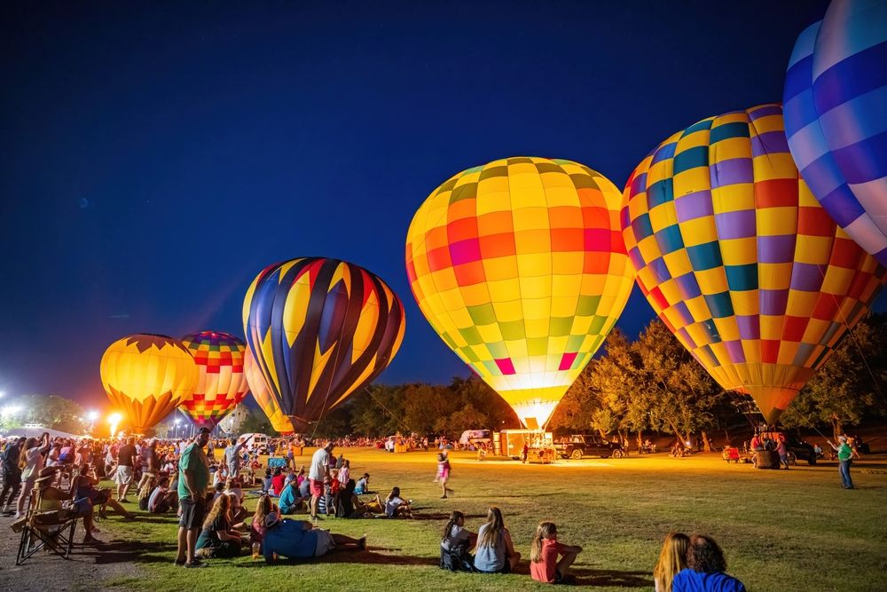 People watching the colorful hot air balloons at the Annual Fireflight Balloon Festival