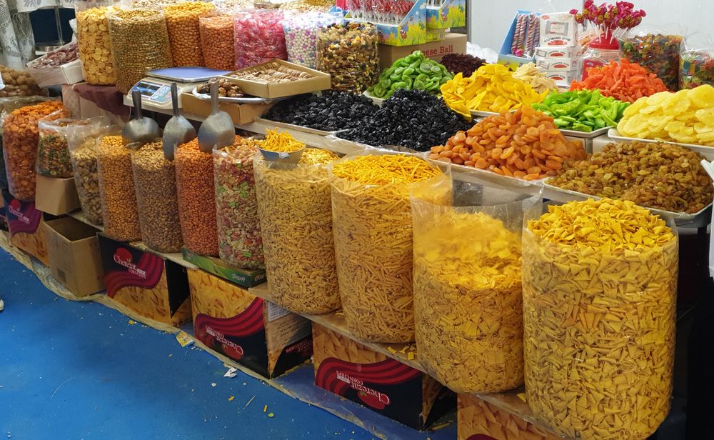 Snacks and dry fruits stacked up for sale at a Souk in Abu Dhabi