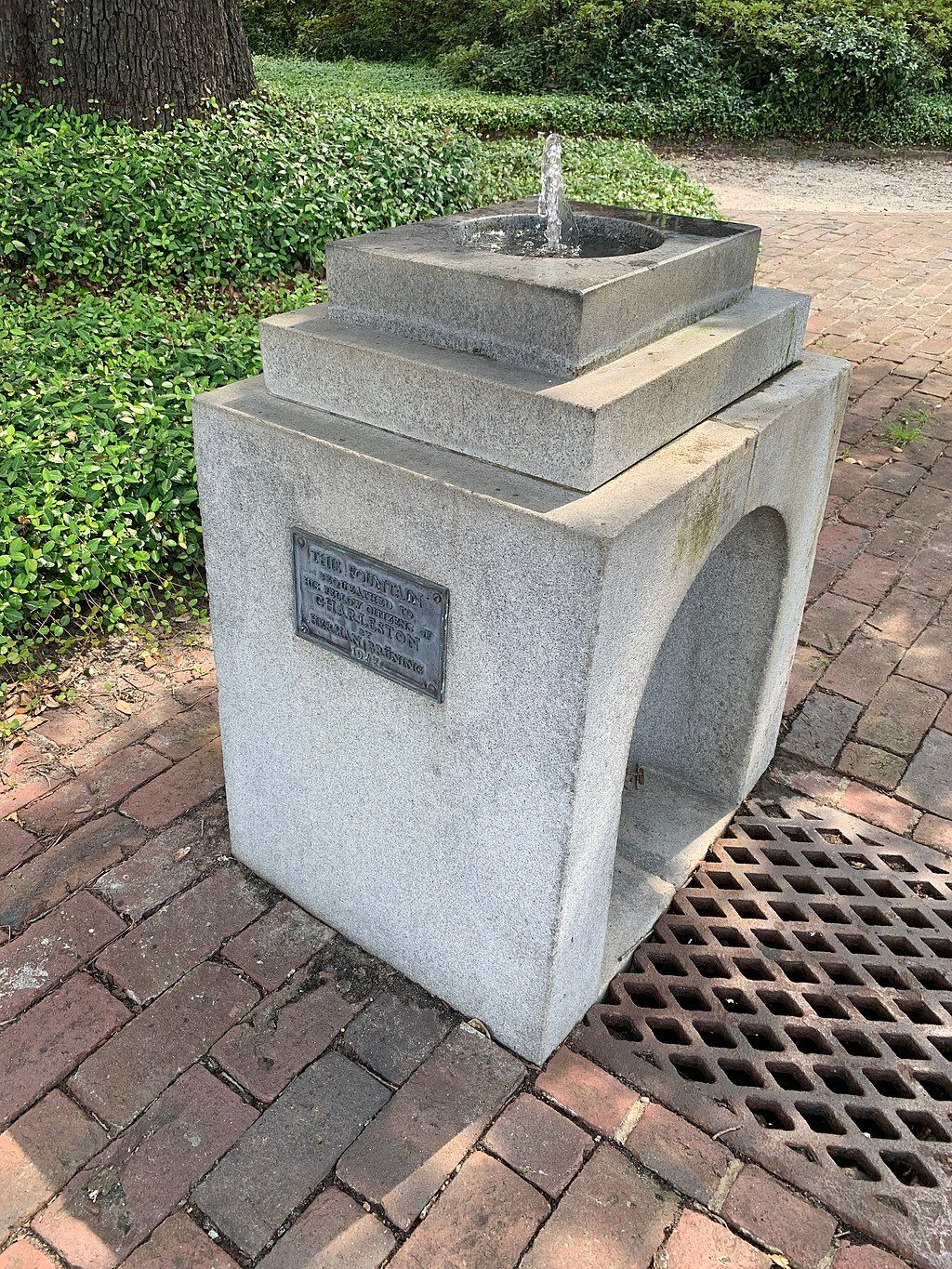 Stone fountain with water coming out of it.