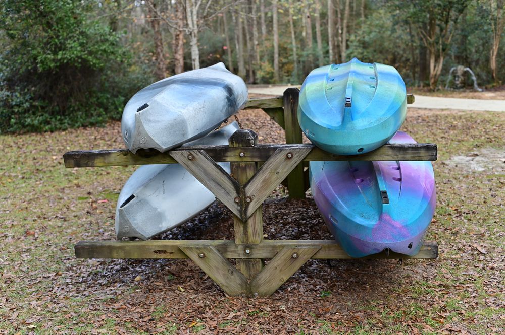A stack of kayak boats on the grounds of Aiken State Park