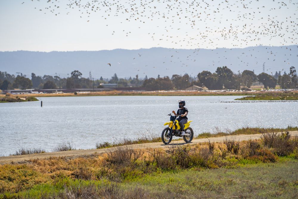 A person riding a motorcycle along Baylands Nature Preserve