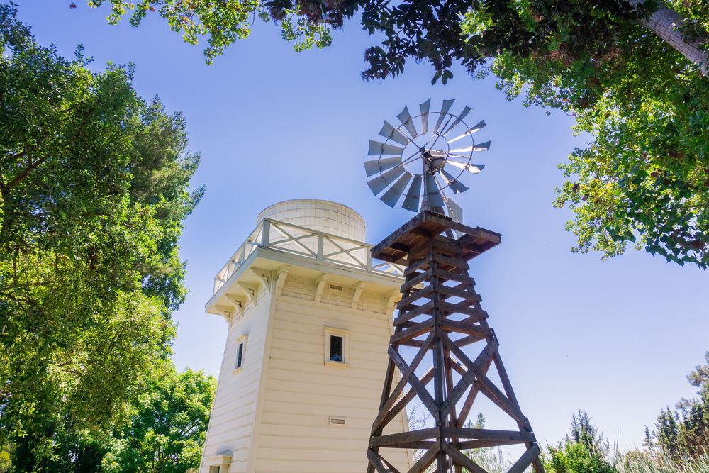 Wind turbine and wooden water tower at Rengstorff House
